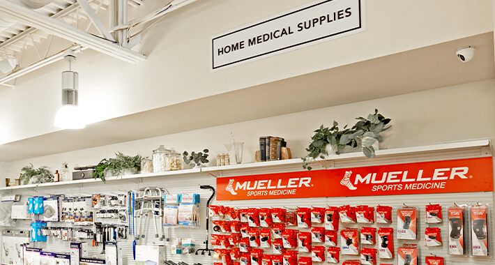 Fitzgerald Pharmacy's Home Medical Supplies aisle filled with knee braces, walkers, canes, and other supplies
