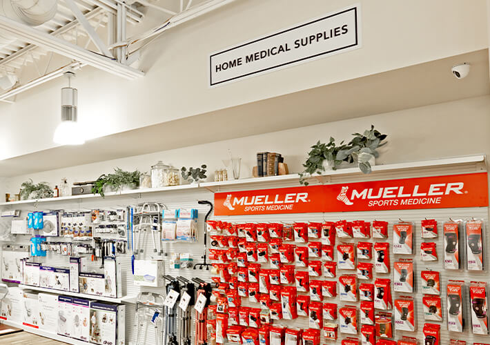 Fitzgerald Pharmacy's Home Medical Supplies aisle filled with knee braces, walkers, canes, and other supplies